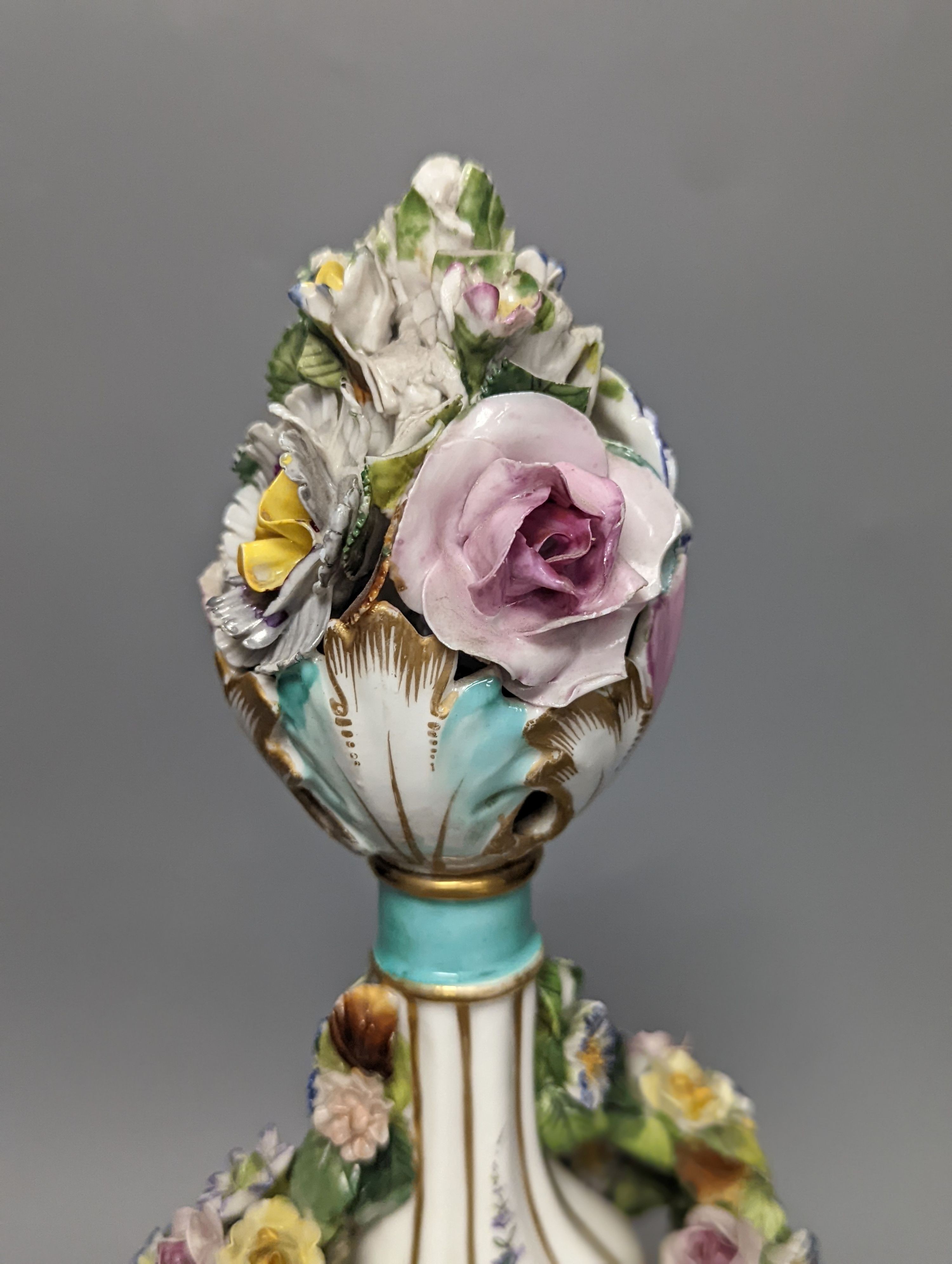 A German porcelain floral encrusted vase and cover 35cm, pseudo crossed swords mark